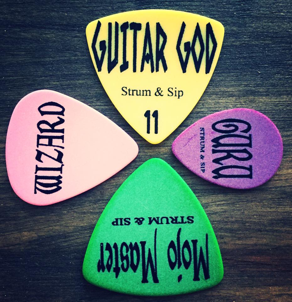 Strum & Sip branded guitar picks showing level tiers — Rockstar, Legends, Wizard