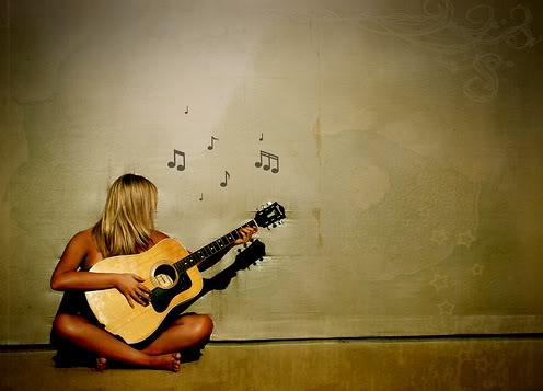 Woman playing guitar at a Strum & Sip class